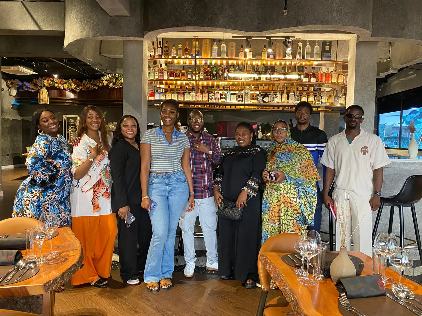 A group standing together in a restaurant dining room during a visit