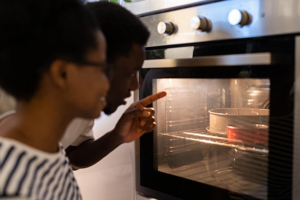 lovely-young-african-american-family-couple-baking-cake-for-special-occasion-together-at-home-sitting_t20_G7QGrY