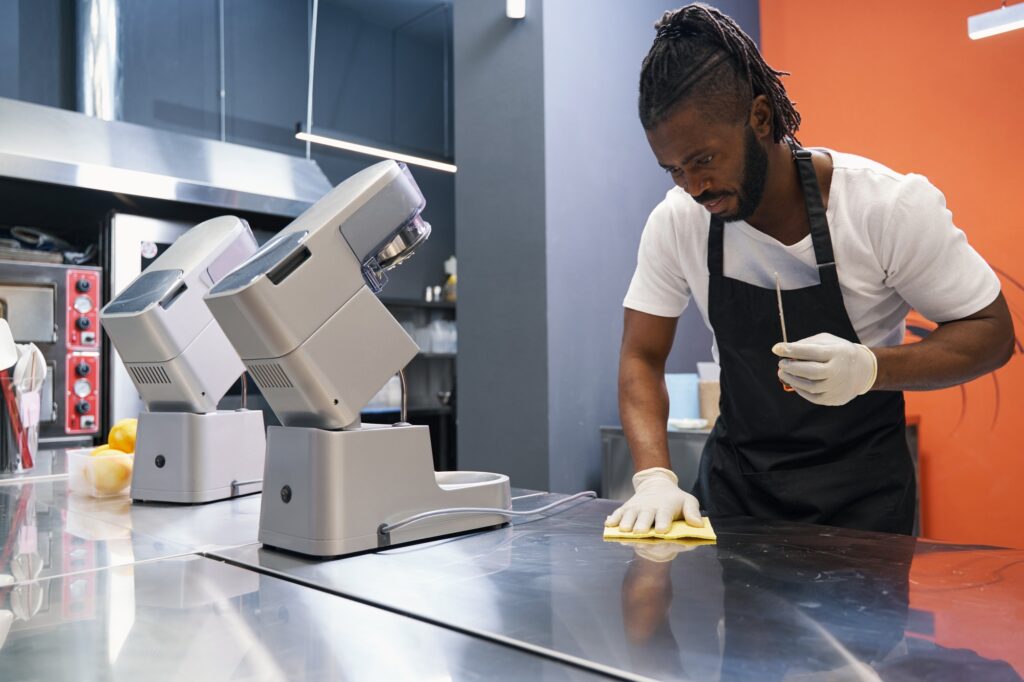 African chef cleaning work place after hard working